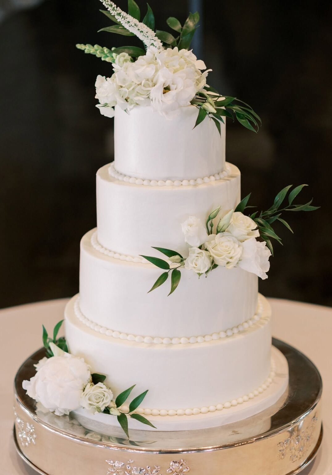 Smooth iced texture wedding cake with beading