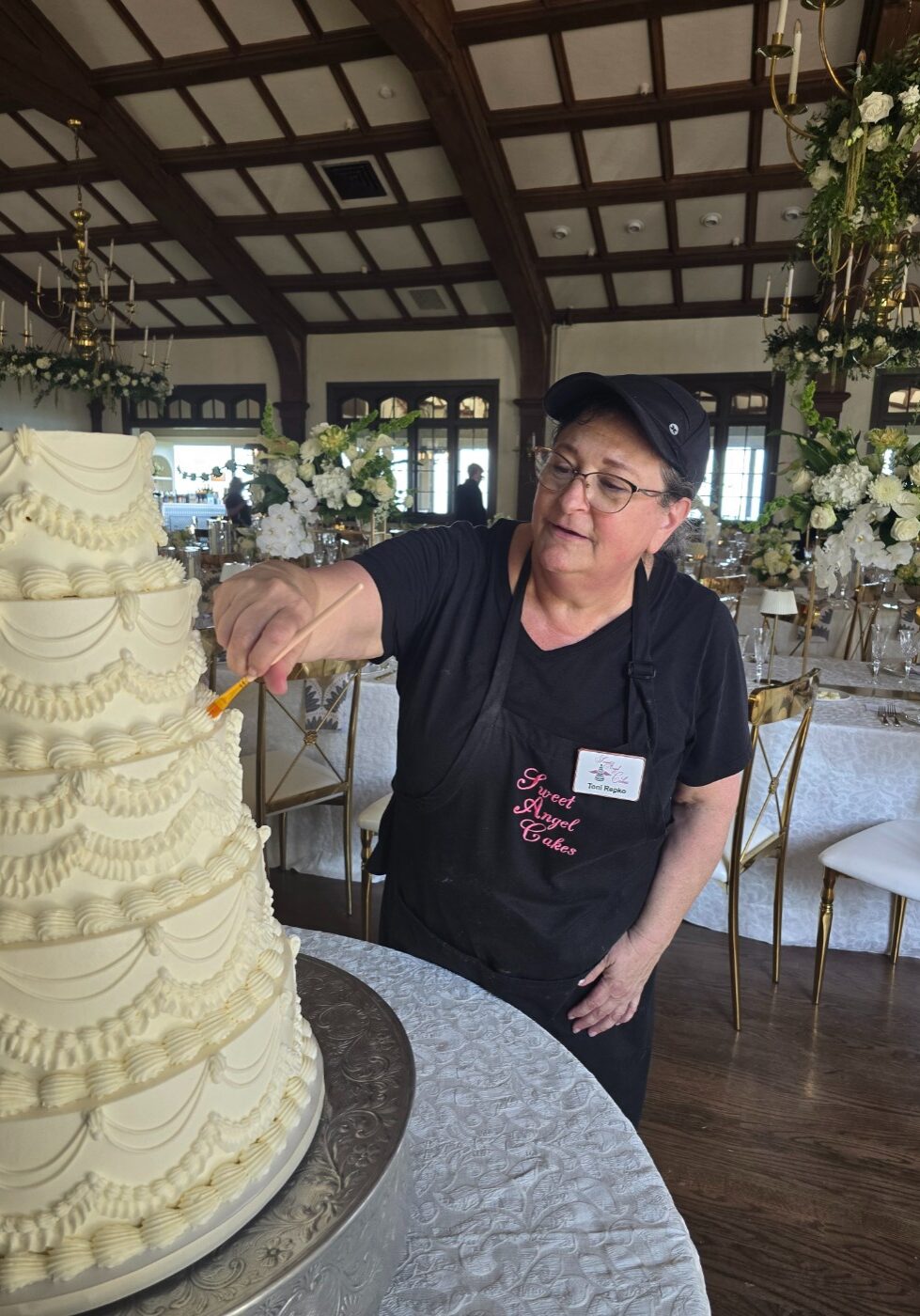Toni adding finishing touches to wedding cake