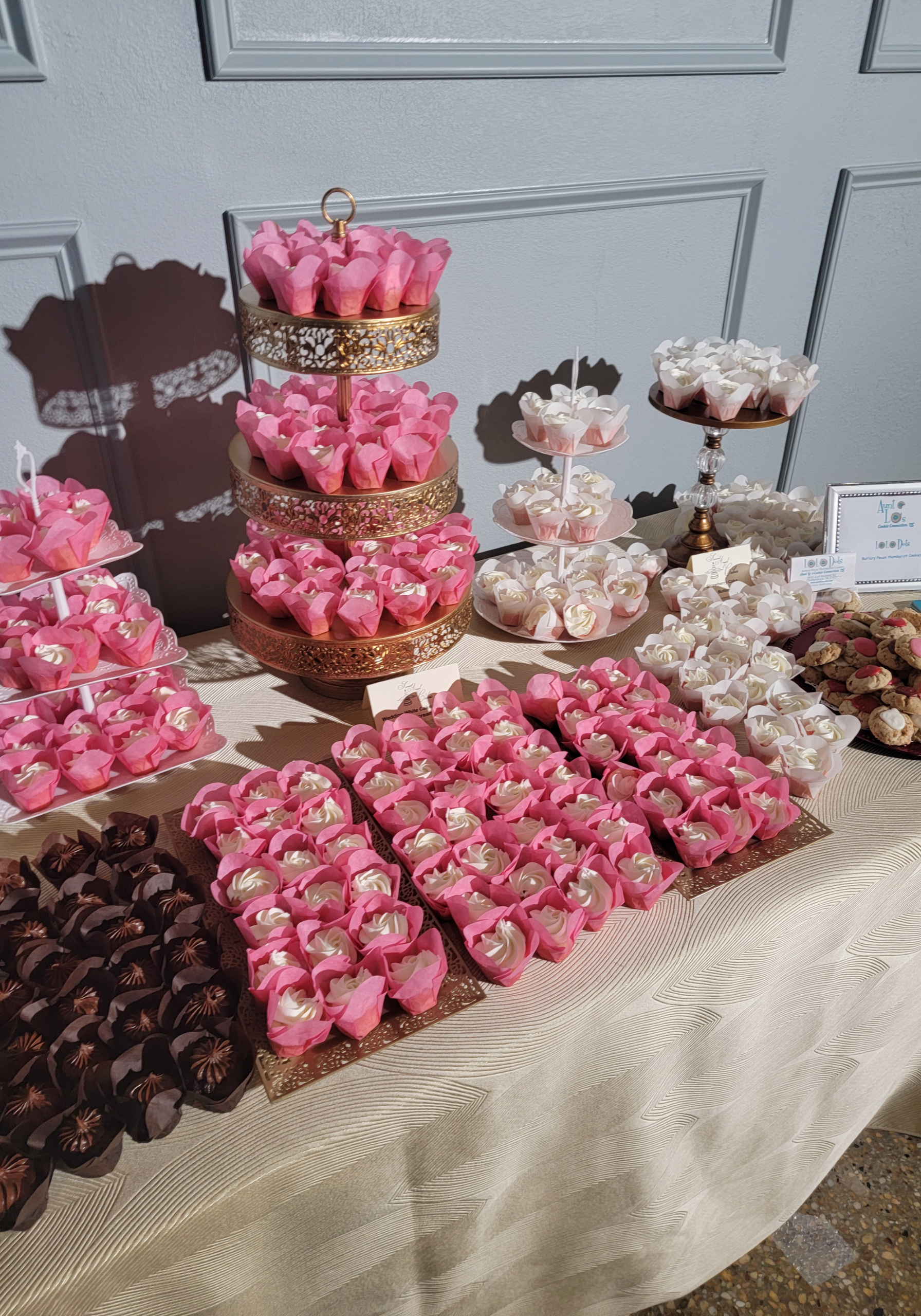 Gold cupcake stands with cupcakes at wedding reception